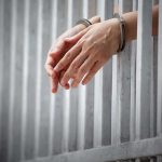 Teen Sex Conviction — Out In 90 Days?! handcuffed hands resting through prison bars