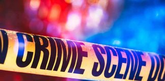 Kratom Clue Found – Campus On Edge Crime scene tape with blurred emergency lights in background