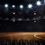 Basketball court under bright arena lights