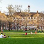 Transparency Meltdown at Elite Universities Students relaxing on a campus quad in front of a brick academic building