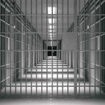 Chilling Delay: Mom Sits, Autopsy Missing empty prison corridor with barred cells