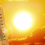 Two-Thirds Of America Under Heat Alarms For Holiday Weekend thermometer in front of a blazing sun and orange sky