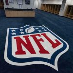 Travis Kelce Named Victim – $31M Vanishes NFL logo on the floor of an empty locker room