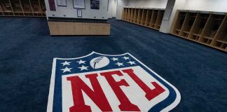 Travis Kelce Named Victim – $31M Vanishes NFL logo on the floor of an empty locker room