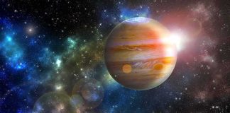 Jupiter in a colorful star field with bright lens flares