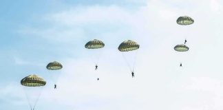 Two-Mile Freefall Miracle – While Unconscious! Parachutists descend under round canopies in a clear sky
