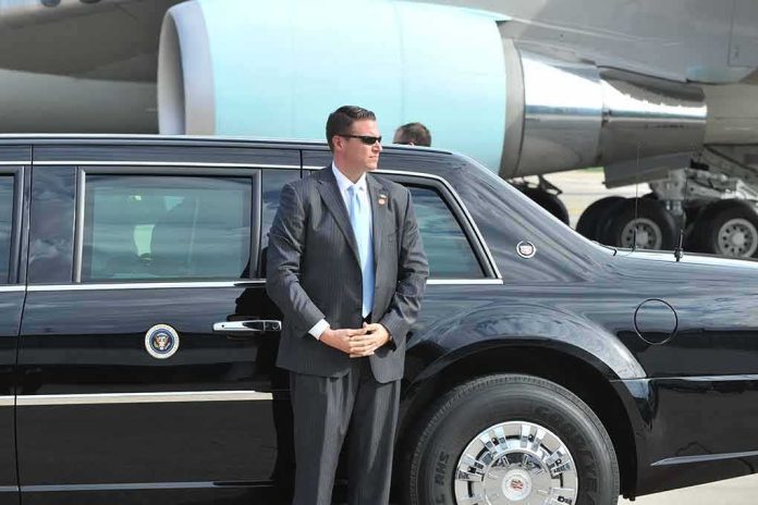 shutterstock_128389715 security agent in suit standing beside black limousine near aircraft
