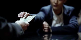 Iran’s Lifelines Vanish Fast Hands exchanging cash across a table
