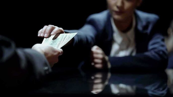 Hands exchanging cash across a table