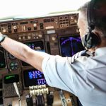 Miracle Pilot’s Stark Diagnosis Stuns Pilot adjusting controls in an airplane cockpit
