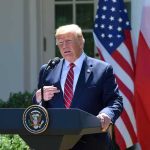 Trump Dangles Perks, Holds The Bomb Line man at presidential podium speaking outdoors