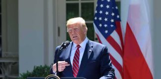 Trump Dangles Perks, Holds The Bomb Line man at presidential podium speaking outdoors