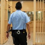 Late-Night Crash Engulfs State Hopeful corrections officer walking through prison corridor