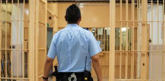 Late-Night Crash Engulfs State Hopeful corrections officer walking through prison corridor