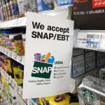 Shelf sign in a grocery aisle showing SNAP EBT acceptance