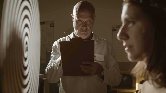 scientist observes subject during experiment with spiral target