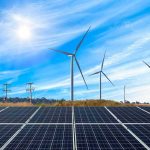 Trump Torches Wind, Solar Lifeline Solar panels with wind turbines in a sunny landscape