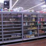 Partially empty store shelves with baby formula and supplies