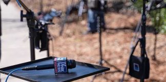 Microphone on a small stand-up table at an outdoor media setup