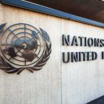 United Nations emblem and signage on a concrete wall