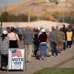 Iowa Showdown: Vance Turns Up Heat voters standing in a long line outside a polling place