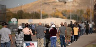 voters standing in a long line outside a polling place