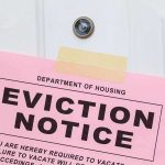 Eviction notice taped to a white door