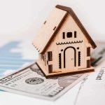 Wallet Squeeze Begins – Fed Gets Tough Wooden house model on money and contract papers
