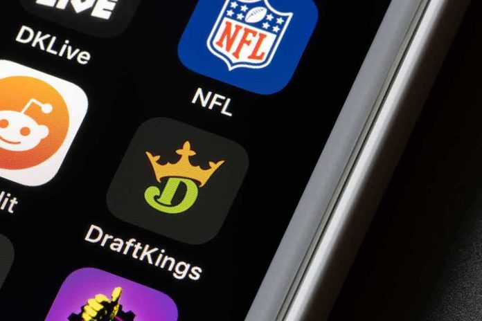 shutterstock_1929600590 Smartphone screen showing NFL and DraftKings app icons