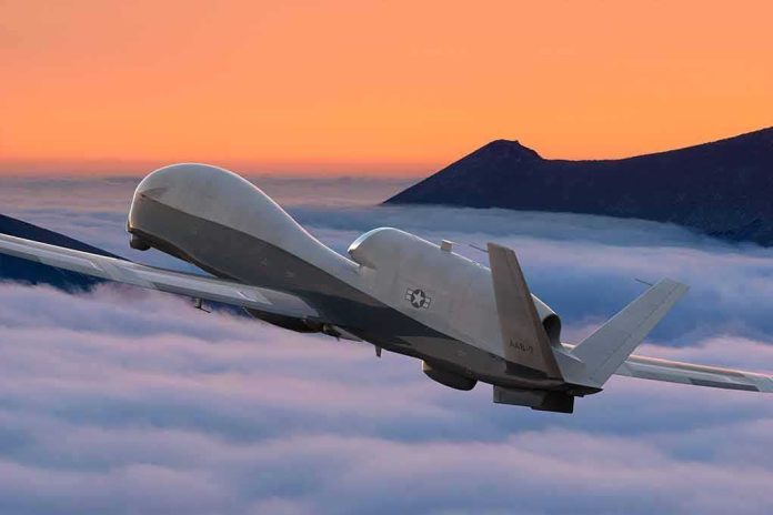 shutterstock_1995230501 military drone flying above clouds at sunset