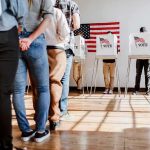 Four Republicans Derail Voter ID Push Voters stand in line and cast ballots at voting booths