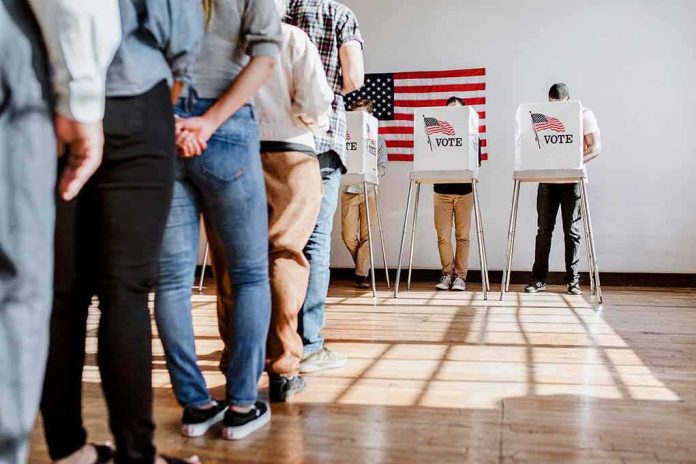 Voters stand in line and cast ballots at voting booths
