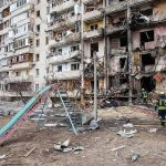 Kyiv Ablaze After Midnight Barrage Damaged apartment building behind a playground slide