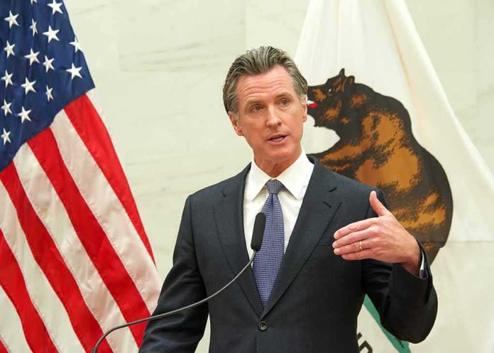 Gavin Newsom speaks at a podium with U.S. and California flags behind him