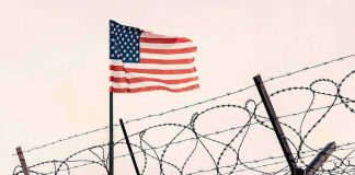 Terror Plot Near US Air Base American flag above barbed wire fence