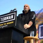 Fetterman’s Shock GOP Cameo Stuns Democrats Speaker at outdoor rally standing at podium with microphone