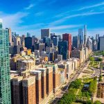 Active Shooter Carnage Rocks High-Rise City skyline with tall glass skyscrapers and urban park