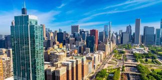 Active Shooter Carnage Rocks High-Rise City skyline with tall glass skyscrapers and urban park