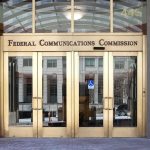 Federal Communications Commission building entrance with gold doors