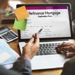 Wall Street Landlords Hit With Ban Laptop displaying refinance mortgage application form