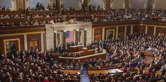 Trump Gets 100% Tariff Hammer Legislative chamber filled with attendees during a formal address