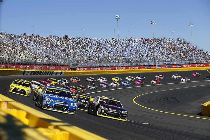 Stock cars racing on a banked track with grandstands in background