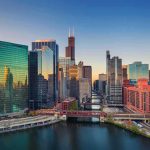 Chicago skyline along the river at sunset
