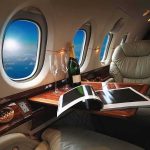 Qatar Jet Becomes Air Force One—Then What? private jet cabin with leather seat, champagne and magazine on table