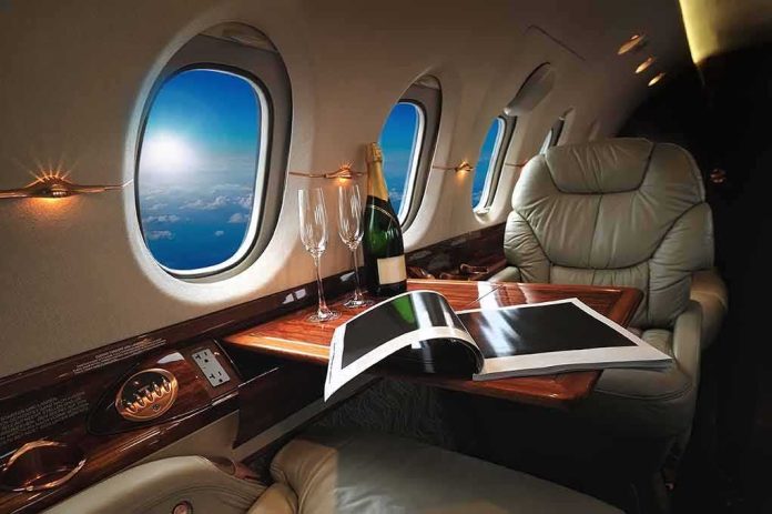 private jet cabin with leather seat, champagne and magazine on table
