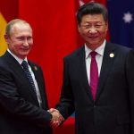 two men in suits shaking hands