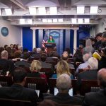 Trump Blocks Reporters – Lawsuit Incoming? Press secretary at podium addressing reporters in briefing room