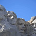 Mount Rushmore Shock: English-Only America? Mount Rushmore granite sculptures against a clear blue sky