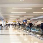 Airport Chaos: Selma Blair Detained, Injuries Alleged Airport terminal with passengers on a moving walkway