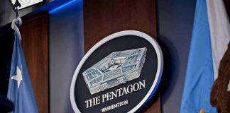Trump Approves Firing Squad – Fort Hood Killer The Pentagon emblem between two flags.